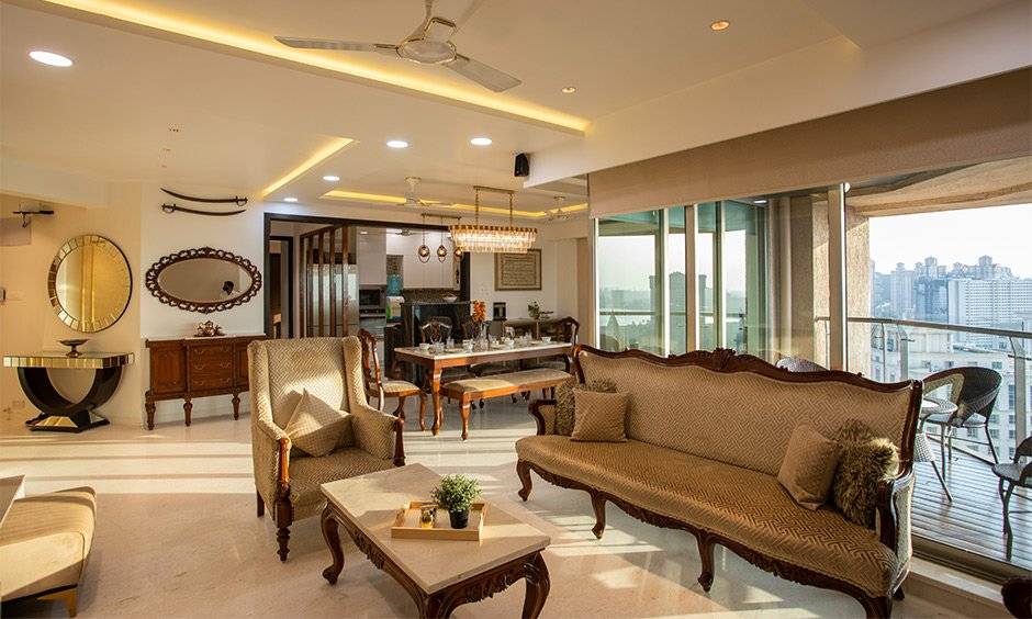 Home interior designers in mumbai with royal wooden sofa set with an antique coffee table with cabriole legs