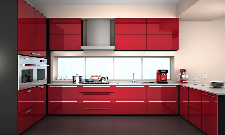 A striking black and white kitchen with red accents in lights and appliances for a dramatic flair