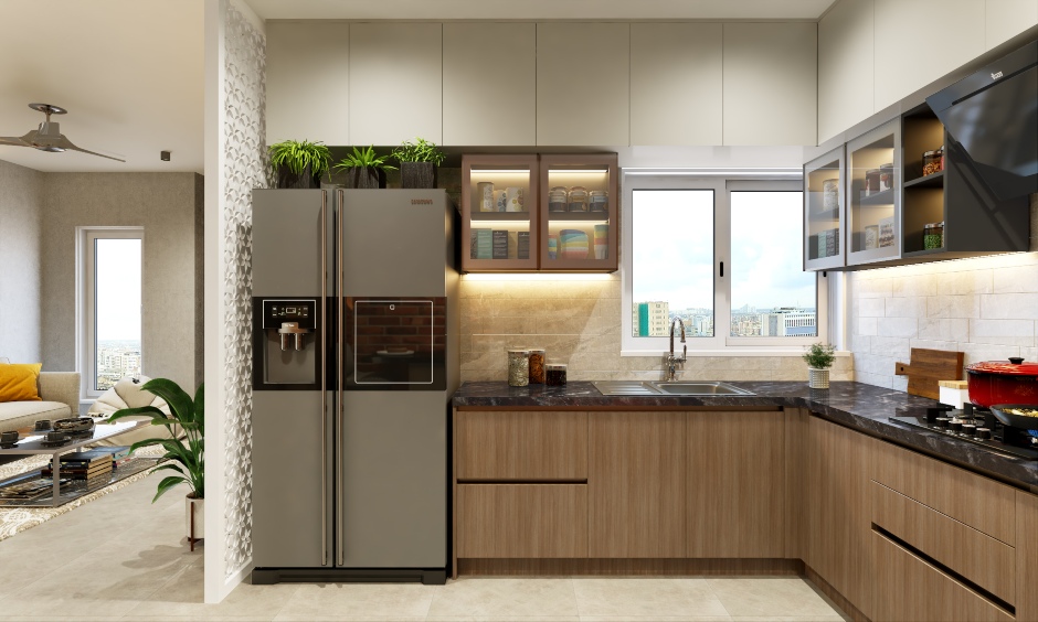 The LED-lit shelves with glass shutters help keep your spice bottles and other kitchen essentials in a 1bhk house design